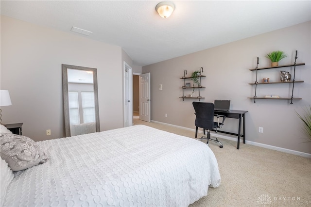 carpeted bedroom with baseboards and an office area