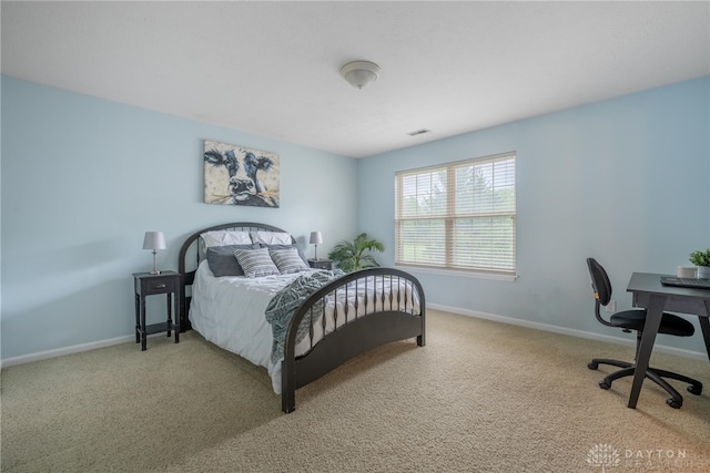 carpeted bedroom featuring baseboards