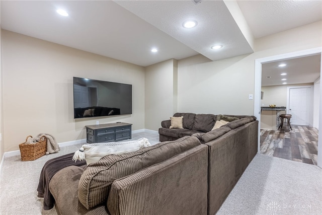living area featuring recessed lighting and baseboards