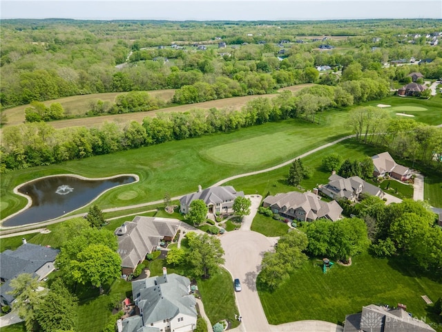 view of property location featuring a nearby body of water, nearby suburban area, and a golf club