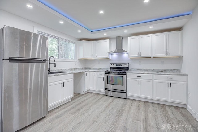 3200 Hoover Ave, Dayton, OH 45402 - kitchen featuring stainless steel appliances, wall chimney exhaust hood, a sink, white cabinets, and recessed lighting