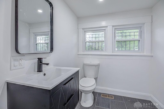 3200 Hoover Ave, Dayton, OH 45402 - bathroom with toilet, baseboards, vanity, and recessed lighting