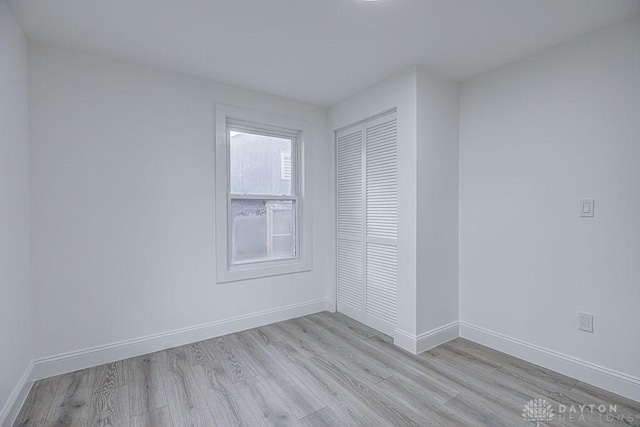 3200 Hoover Ave, Dayton, OH 45402 - unfurnished bedroom with light wood finished floors, baseboards, and a closet