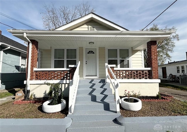 view of front of house featuring a porch and brick siding