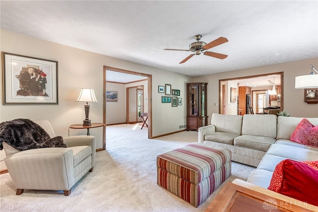 2100 Hunters Bluff Ct, Washington Twp, OH 45458 - living room with light carpet, a ceiling fan, baseboards, and a textured ceiling