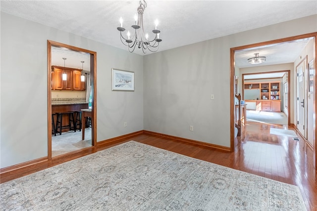 2100 Hunters Bluff Ct, Washington Twp, OH 45458 - dining room with hardwood / wood-style floors, a chandelier, and baseboards