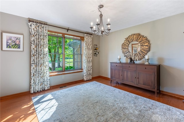 2100 Hunters Bluff Ct, Washington Twp, OH 45458 - unfurnished room with a chandelier, baseboards, and wood finished floors