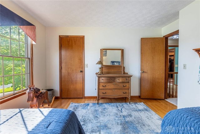 2100 Hunters Bluff Ct, Washington Twp, OH 45458 - bedroom with multiple windows, wood finished floors, and a textured ceiling