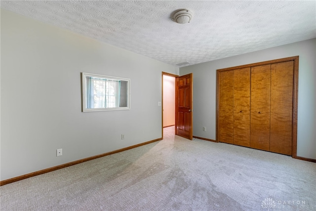 2100 Hunters Bluff Ct, Washington Twp, OH 45458 - unfurnished bedroom featuring light colored carpet, a textured ceiling, baseboards, and a closet