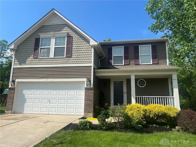 868 Grande Oaks Dr, Morrow, OH 45152 - view of front of property featuring driveway, an attached garage, brick siding, and covered porch