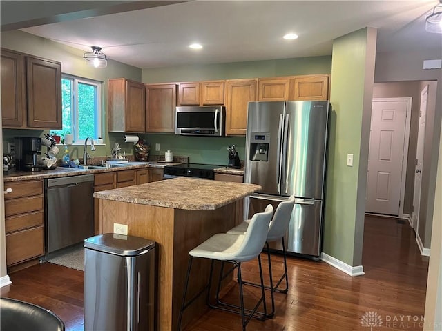 868 Grande Oaks Dr, Morrow, OH 45152 - kitchen with stainless steel appliances, a center island, a breakfast bar area, dark wood-style flooring, and recessed lighting