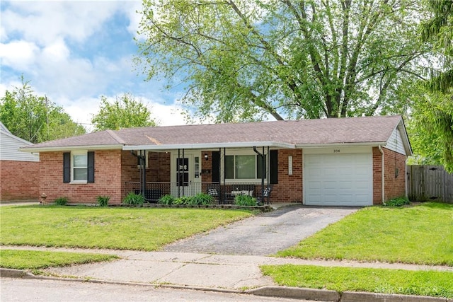 ranch-style house featuring a garage, covered porch, brick siding, and asphalt driveway