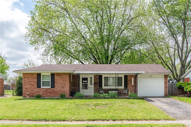 ranch-style house featuring covered porch, an attached garage, driveway, and brick siding