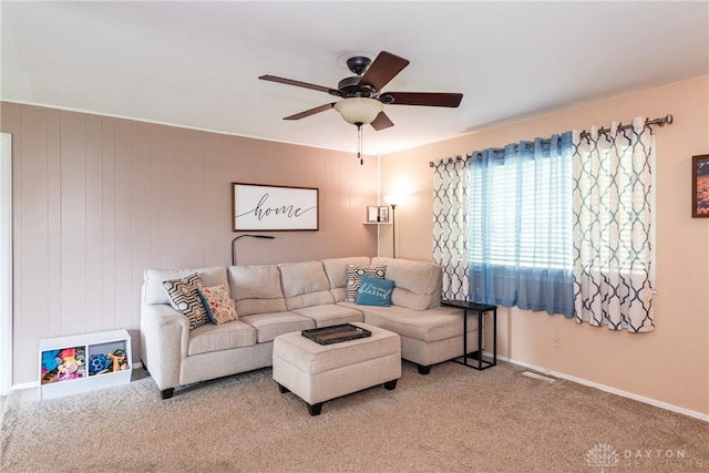 living room with ceiling fan, carpet floors, and baseboards