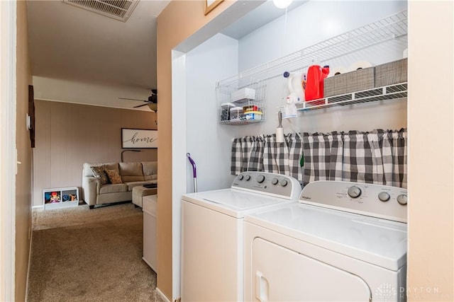 clothes washing area with carpet floors, a ceiling fan, and washer and clothes dryer