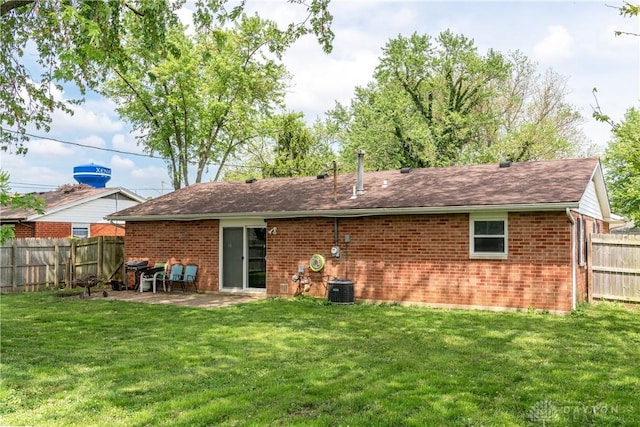 rear view of property with brick siding, central AC, and a patio area