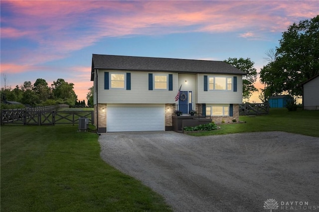 7217 State Route 380, Chester Twp, OH 45177 - raised ranch featuring an attached garage, driveway, and brick siding