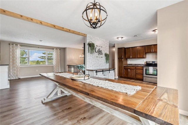 7217 State Route 380, Chester Twp, OH 45177 - dining space featuring a chandelier, baseboards, and wood finished floors
