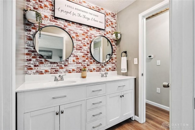 7217 State Route 380, Chester Twp, OH 45177 - full bathroom with wood finished floors, double vanity, and baseboards