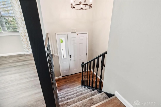 7217 State Route 380, Chester Twp, OH 45177 - foyer with a chandelier, wood finished floors, stairs, and baseboards