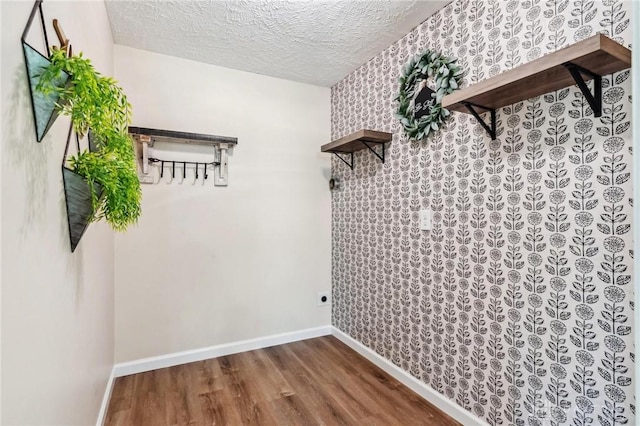 7217 State Route 380, Chester Twp, OH 45177 - laundry room with wood finished floors, a textured ceiling, baseboards, wallpapered walls, and electric dryer hookup