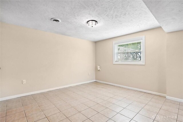 7217 State Route 380, Chester Twp, OH 45177 - unfurnished room with a textured ceiling, baseboards, and light tile patterned floors