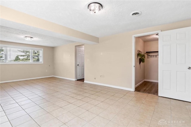 7217 State Route 380, Chester Twp, OH 45177 - unfurnished room featuring a textured ceiling, light tile patterned floors, and baseboards