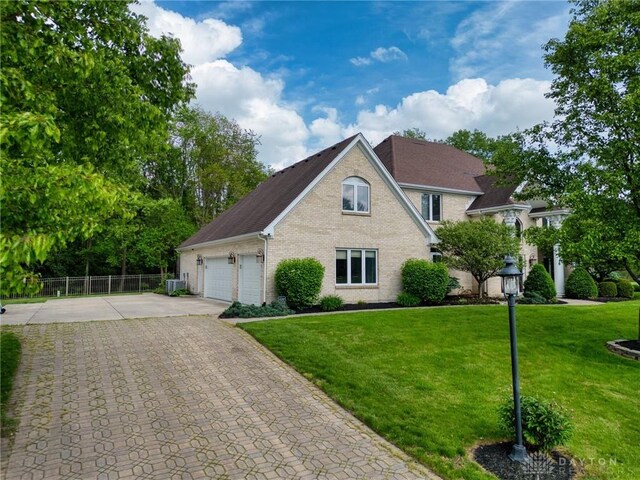 1656 Fox Trl, Bellbrook, OH 45305 - traditional-style home featuring concrete driveway, brick siding, central AC, and a garage