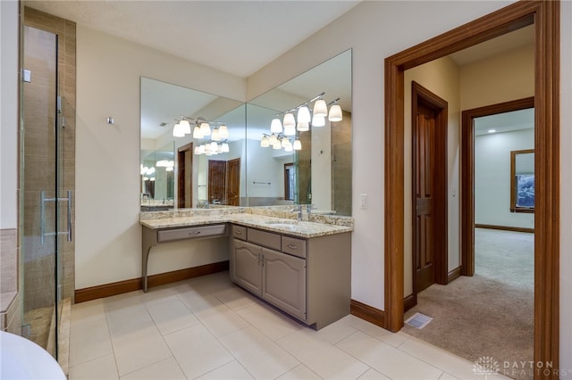 1656 Fox Trl, Bellbrook, OH 45305 - bathroom featuring baseboards, a chandelier, vanity, tile patterned flooring, and a shower