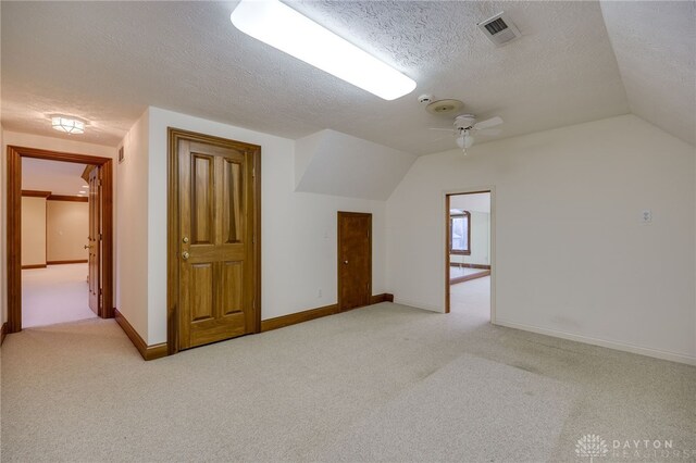 1656 Fox Trl, Bellbrook, OH 45305 - additional living space with light carpet, vaulted ceiling, a textured ceiling, ceiling fan, and baseboards