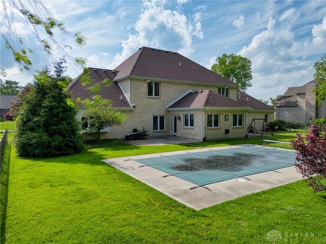 1656 Fox Trl, Bellbrook, OH 45305 - rear view of property featuring a patio area, a shingled roof, and brick siding