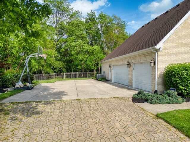 1656 Fox Trl, Bellbrook, OH 45305 - garage with fence, driveway, and central air condition unit