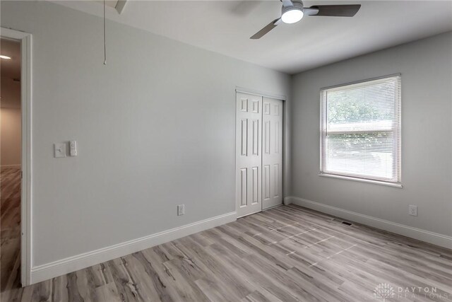 6399 Kimberly Dr, Fairfield Twp, OH 45011 - unfurnished bedroom with a closet, light wood-style flooring, baseboards, and ceiling fan