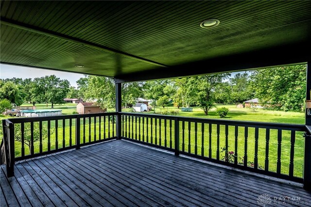 6399 Kimberly Dr, Fairfield Twp, OH 45011 - deck with a storage unit, an outbuilding, a lawn, and view of scattered trees
