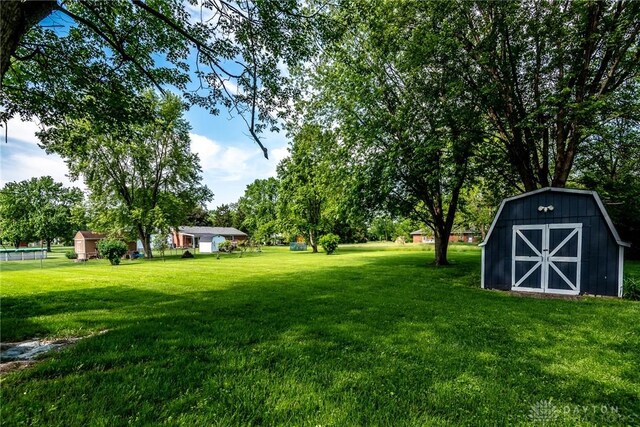 6399 Kimberly Dr, Fairfield Twp, OH 45011 - view of green lawn with an outbuilding and a shed