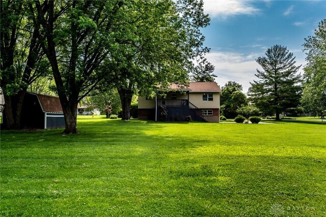 6399 Kimberly Dr, Fairfield Twp, OH 45011 - view of grassy yard featuring an outdoor structure and a storage shed
