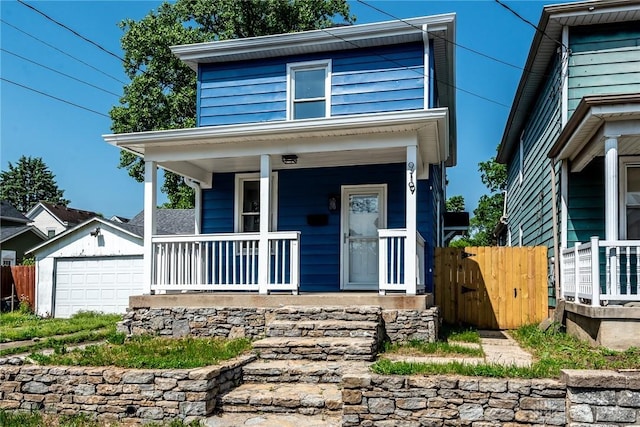 919 Summer St, Hamilton, OH 45013 - view of front facade featuring covered porch, fence, an outbuilding, and a garage
