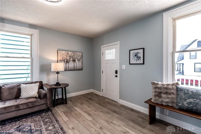 919 Summer St, Hamilton, OH 45013 - entryway with light wood-type flooring, baseboards, and a textured ceiling