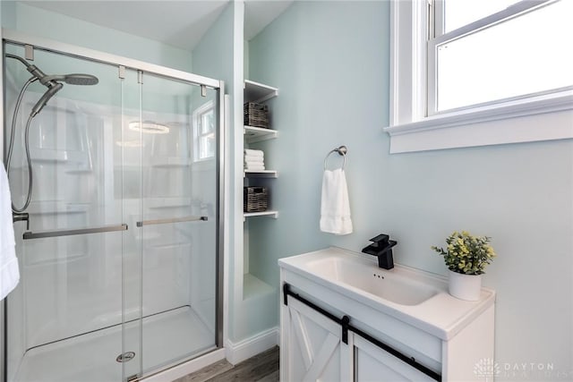919 Summer St, Hamilton, OH 45013 - bathroom featuring a shower stall, wood finished floors, and vanity