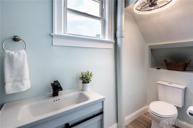 919 Summer St, Hamilton, OH 45013 - half bathroom with toilet, baseboards, vanity, and wood finished floors