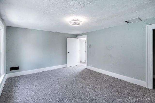 919 Summer St, Hamilton, OH 45013 - empty room featuring carpet, a textured ceiling, baseboards, and attic access