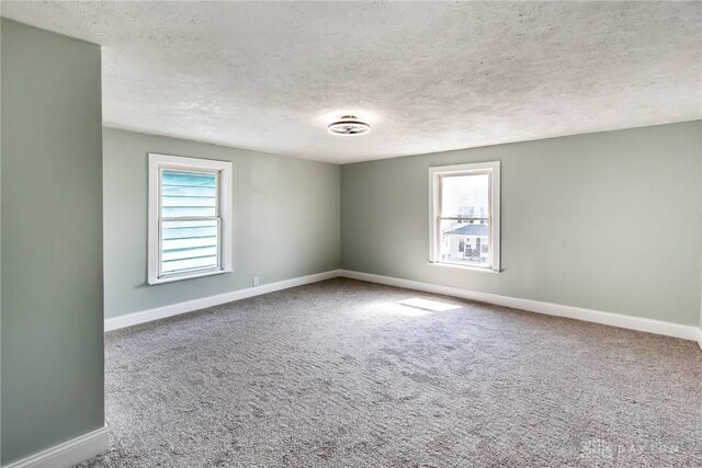 919 Summer St, Hamilton, OH 45013 - empty room featuring a textured ceiling, baseboards, and carpet floors