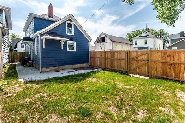 919 Summer St, Hamilton, OH 45013 - rear view of house featuring a patio and a chimney