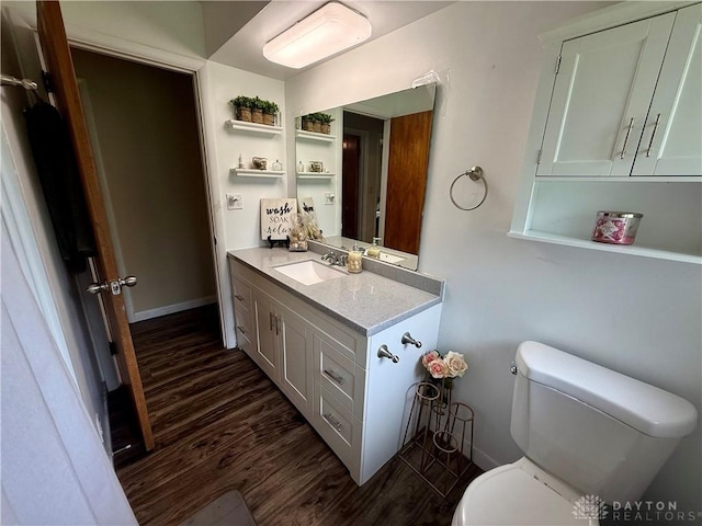 4065 Locustwood Dr, Dayton, OH 45429 - bathroom with wood finished floors, vanity, toilet, and baseboards