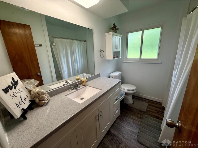 4065 Locustwood Dr, Dayton, OH 45429 - bathroom with vanity, wood finished floors, toilet, and baseboards