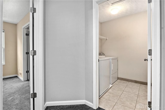 5065 Cross Creek Ln, Miami Township, OH 45150 - laundry room with washing machine and clothes dryer, a textured ceiling, baseboards, and light tile patterned floors