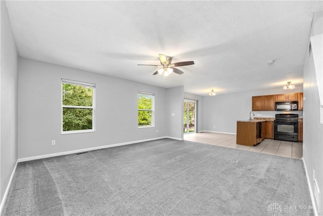 5065 Cross Creek Ln, Miami Township, OH 45150 - unfurnished living room with a sink, light colored carpet, a ceiling fan, baseboards, and light tile patterned floors