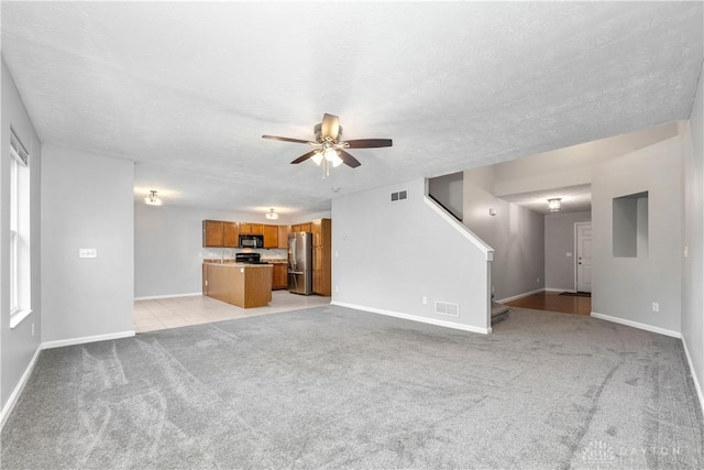 5065 Cross Creek Ln, Miami Township, OH 45150 - unfurnished living room with ceiling fan, light carpet, baseboards, and a textured ceiling