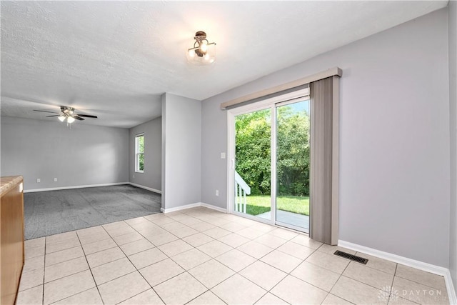 5065 Cross Creek Ln, Miami Township, OH 45150 - spare room featuring baseboards, ceiling fan, light tile patterned floors, and a textured ceiling
