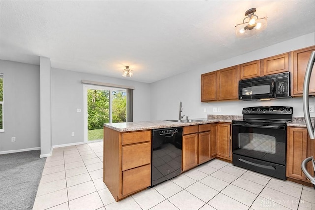 5065 Cross Creek Ln, Miami Township, OH 45150 - kitchen featuring black appliances, a sink, a peninsula, and brown cabinets